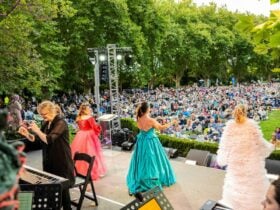 A view from behind stage with performers taking a bow