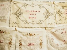 an embroidered dowry with green lacing then in red text centred stating 