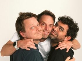 Hugh van Cuylenburg, Ryan Shelton and Josh van Cuylenbu posing together in front of white wall