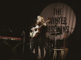 Woman with guitar performing on stage