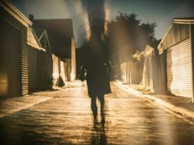 Lone figure walking in the dark