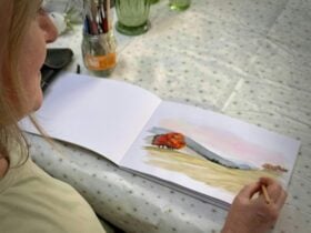 picture of the artist painting the TEACS watercolour logo