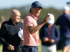 Anthony Quayle holding a golf ball
