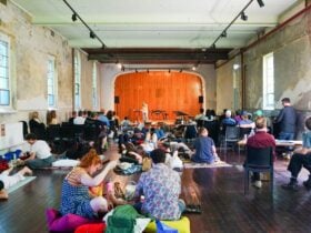 People enjoying Warm Mids - seated on chairs or on the floor