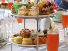 High tea set up with a glass of mimosa on a table