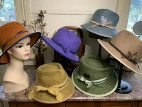 Six felt hats displayed on mannequin heads