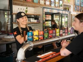 Bar tender serving a customer at the bar