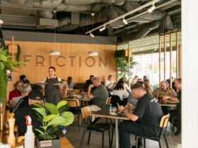 Inside of Friction showing a busy cafe environment with helpful staff.