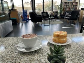 a photo of a cup of coffee and a cake.
