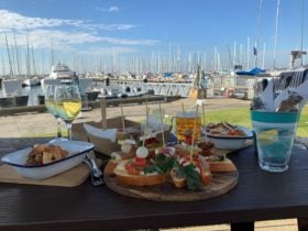 A few of our menu items on the deck with the yacht view in the background