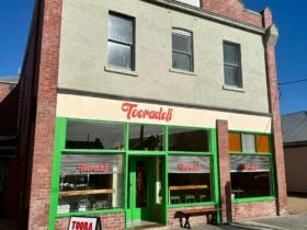 Photo of Tooradeli Exterior with A-Frame sign reading ‘TOORA DELI OPEN’