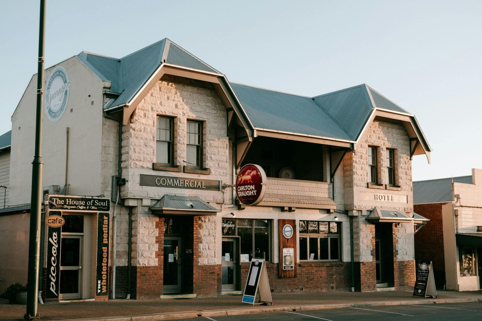 sandstone building with twin jerkin roof at sunset