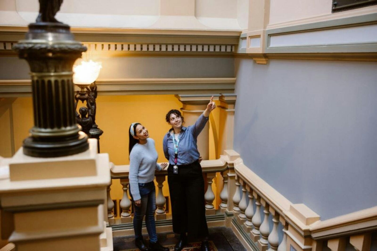 A visitor servicing staff member directing a tour participant