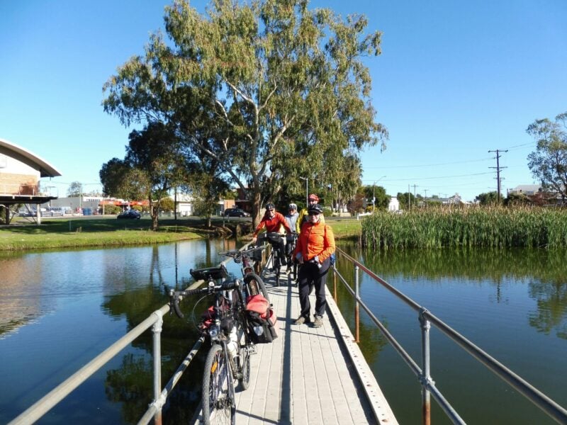 Cyclist crossing bridge Forbes Lake