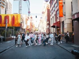 A tour group are crossing the road in Chinatown.