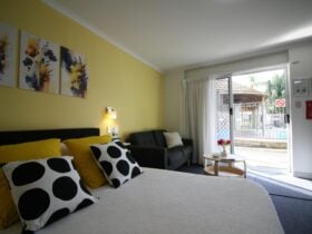 Queen sized bed with couch in background