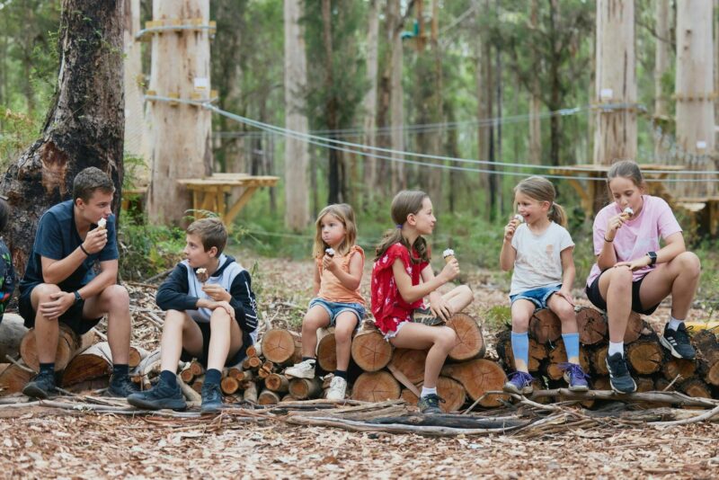 Young kids and teens enjoying an ice cream from the local cafe, in the Gloucester National Park.