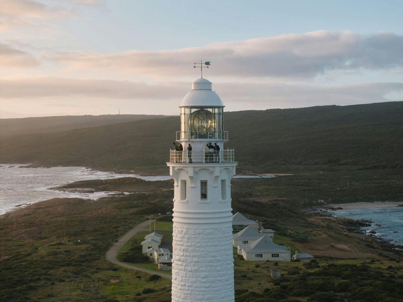 People stand on the balcony of Cape Leeuwin Lighthouse.
