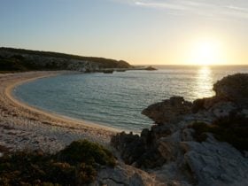 View of large bay with sunset of the water.