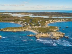 Aerial view of island with beaches, and coastal headlands.