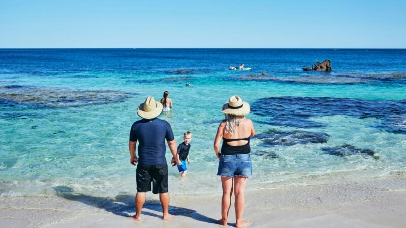 Family standing at water