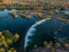 Aerial shot of Ivanhoe Crossing with water flowing and a car crossing