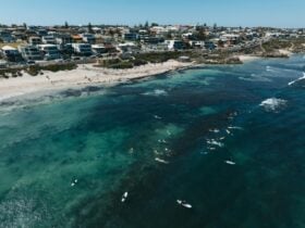 Surfers and snorkellers enjoying the clear waters at Perth's best snorkelling spot, Mettams Pool