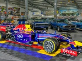 Daniel Ricciardos 3x winning 2014 Red Bull RB10 inside Ricciardo Hall in front of Ford Muscle Cars