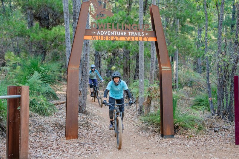 A female mountain bike rider going through the Murray Valley Mountain Bike Trails trailhead