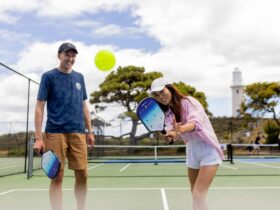 Two people playing pickleball on an outdoor court at Rotto Rackets Sports on Rottnest Island.