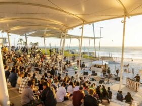 A crowd of people enjoying live music and the ocean views at Scarborough Beach Amphitheatre