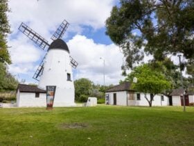 Old Mill and cottage with grass and trees
