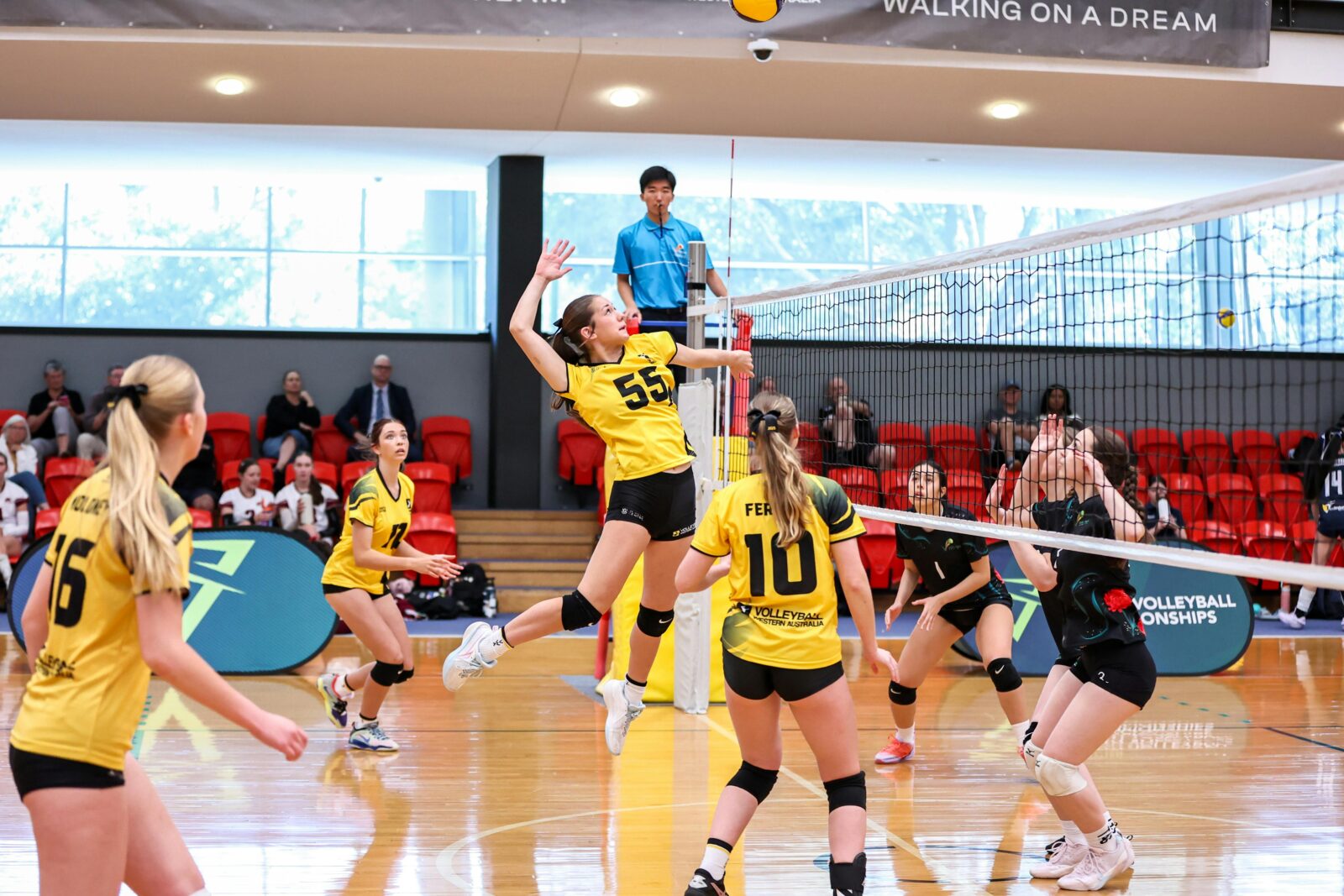 Young adults playing volleyball