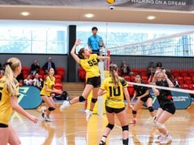 Young adults playing volleyball