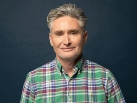 Man In green shirt looks at camera