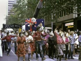 Demonstrators dressed as zombies take part in a protest.