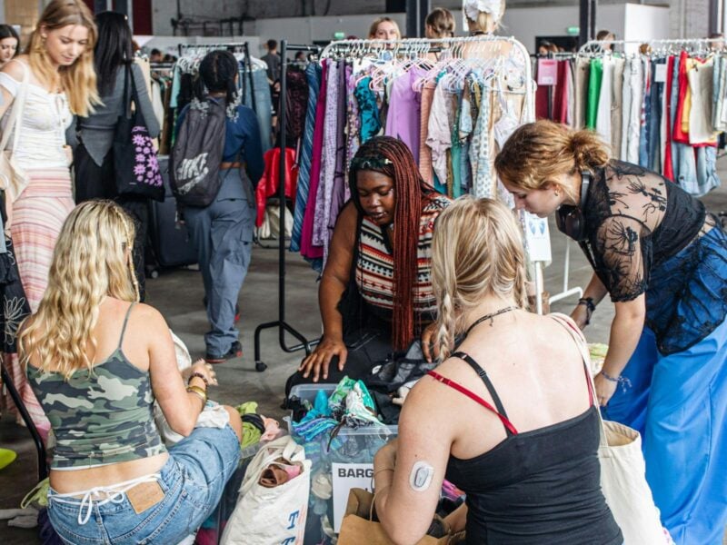 people rummaging through clothing sale bins