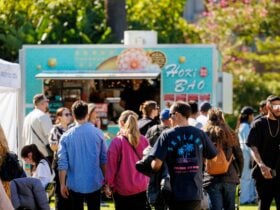 People in a crowd in front of a food truck