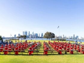 A large group of Gunzheng players dressed in red and playing on the South Perth foreshore