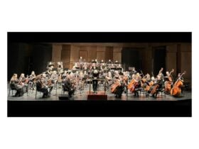 Image of conductor and orchestra
