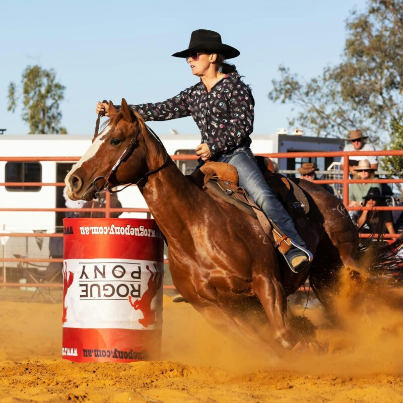 Horse and Rider going around a Barrel in the arena