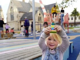 Young girl playing with LEGO toy in Walyalup Koort
