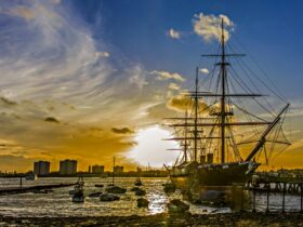 a sunset image of a ship in a marina