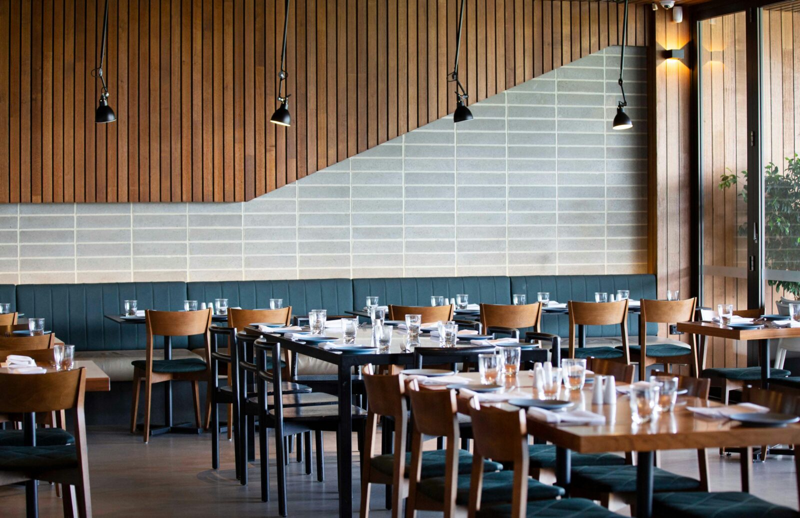 Inside dining room at 300 Acres restaurant Wembley Golf Course Perth, featuring timber panelling