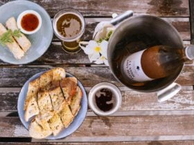 A overhead shot of a table at Surfer Girl, laid with food & wine