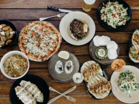 Long table at Eagle Bay brewery, full of lunch staples including pizza, tacos and steak.