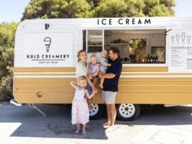 Photo of co owners Mati and Kaitlyn Kuld with their three children infront of the Kuld caravan.