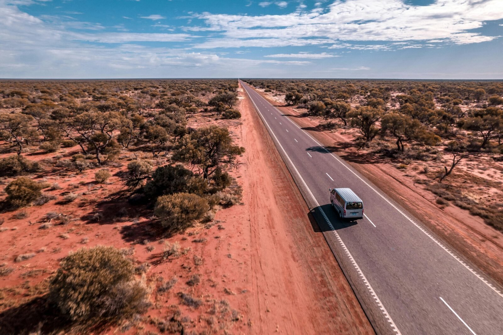 Home on the Road rental campervan driving along a highway in Western Australia